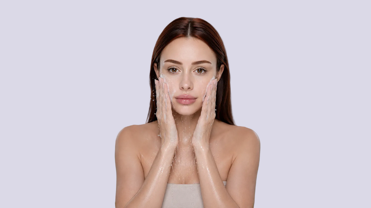 Woman using a facial cleanser