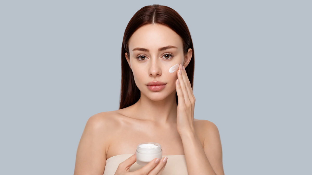 Woman applying a retinol skincare product