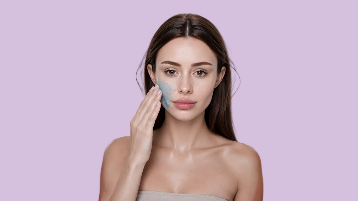 Woman applying an exfoliating skincare product