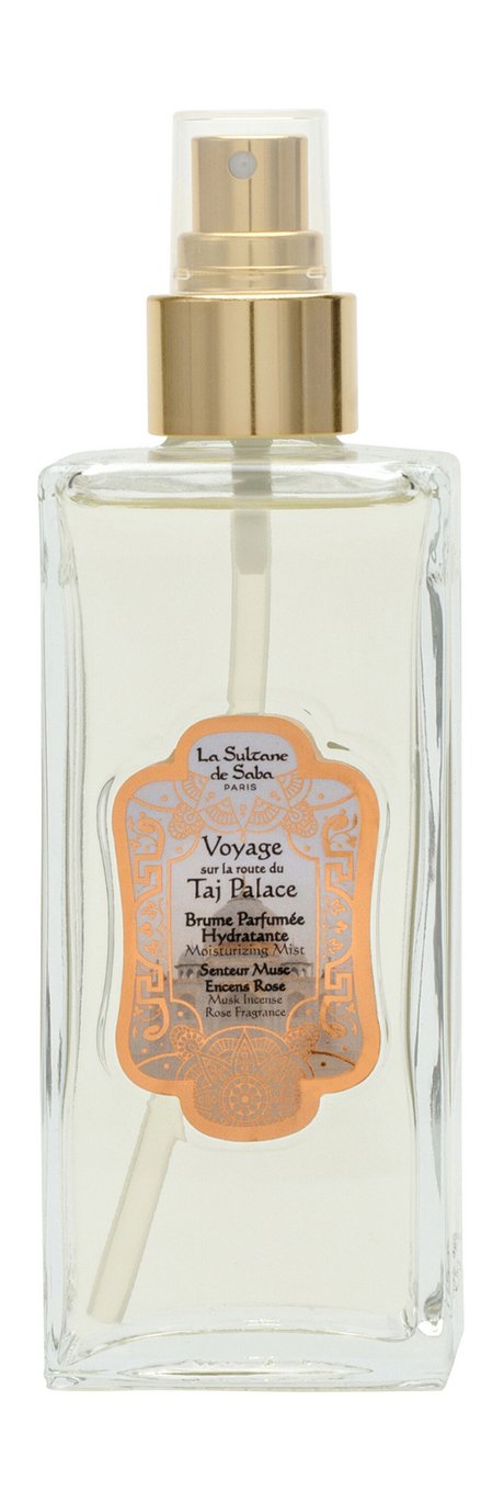 A clear glass spray bottle of a La sultan de saba, featuring a gold pump collar and a decorative orange label on a white background.