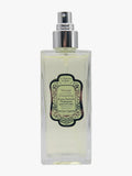 A rectangular glass perfume bottle with a silver spray nozzle and a decorative black and green label, containing a pale yellow liquid, shown against a plain white background.