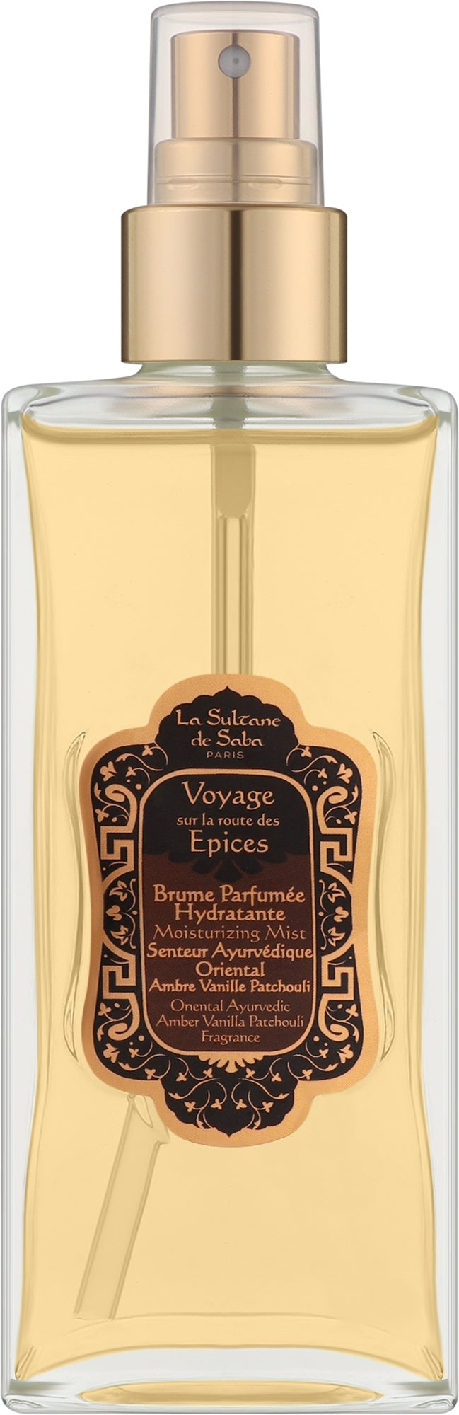 A clear glass spray bottle filled with pale yellow liquid, featuring a metallic gold pump and a dark brown ornate label with gold lettering. The label reads 'Le Scent de la Terre' and 'Voyage des Épices'.