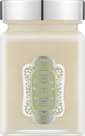 A jar candle with a silver metal lid and a cream-colored wax inside, featuring a decorative green and white label that reads 'Le Souffle du Sel Paris' and 'Voyage de la musc de D'arjeeling'.